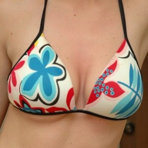 Amys huge boobs are popping out of her bikini top