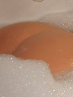 Cute Ruby loves to show off her tight round ass in a bubble bath