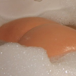 Cute Ruby loves to show off her tight round ass in a bubble bath