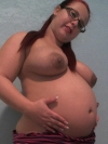 Cock teasing pregnant pornstar Georgia Peach strips out of her striped jumper exposing her huge tits and big swollen stomach